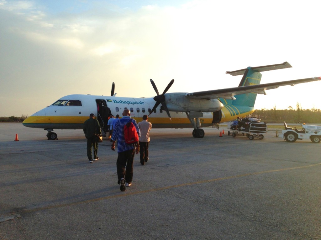 The sunrise outlined the still propellers of our well-aged Dash 8.