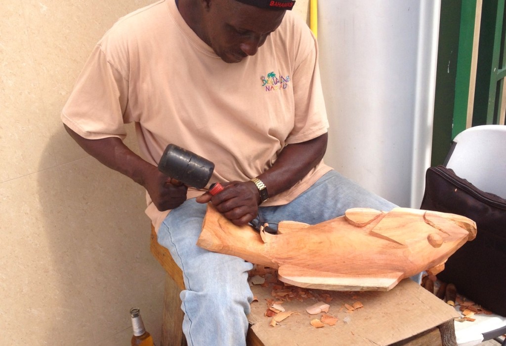 A man carving a fish to sell at the Straw Market.