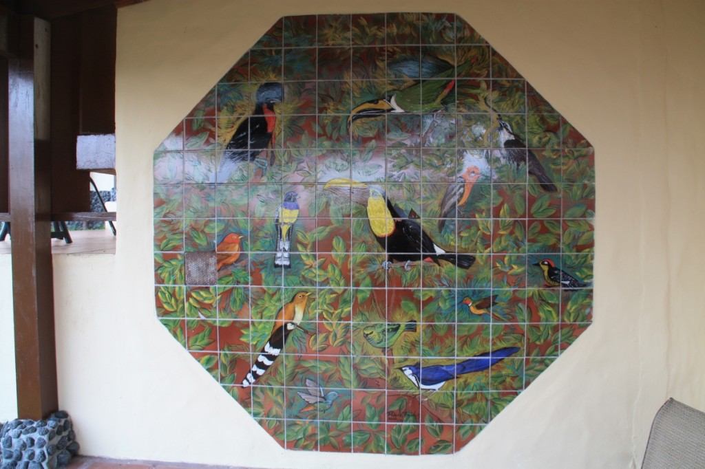 Colorful bird themed tiled artwork on the terrace.