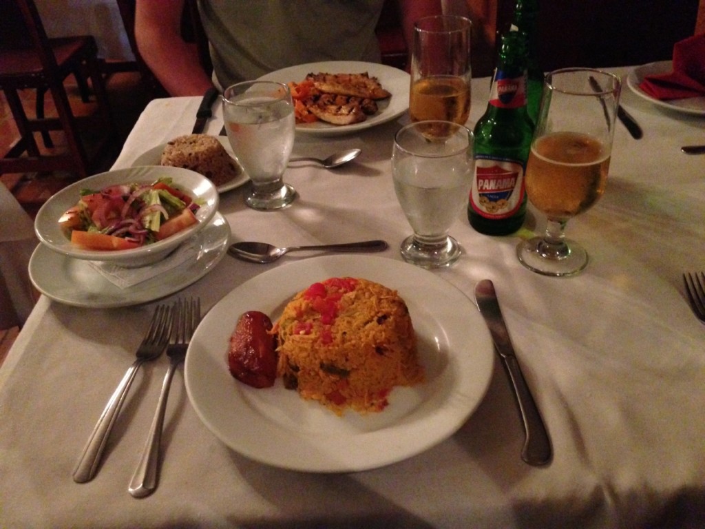 Arroz con pollo (rice with chicken) and a local beer.