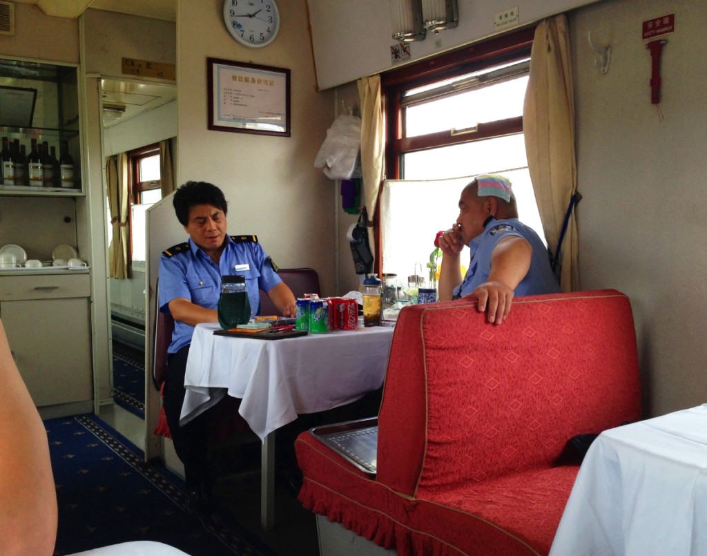 Train police having a meal and a towel on the head to cool off.. why not?